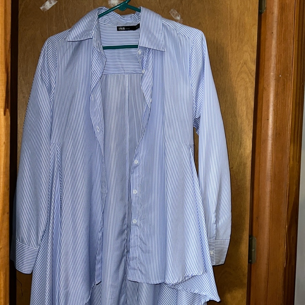 Long in the back short in the front blue and white striped blouse.